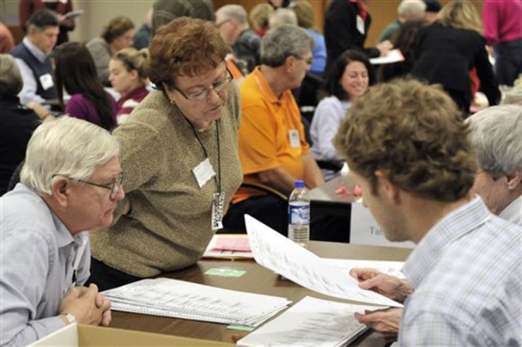 Observers for both gubernatorial candidates, left, oversee the ballot recount in the Minnesota governor's race which began on Monday in Minneapolis. Democrat Mark Dayton is hoping the recount confirms his nearly 8,800-vote lead over Republican Tom Emmer. More than 2.1 million votes must be recounted in a process that will run into next week. 